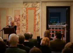 Picture of person holding a lecture at Villa Lante with audience in the foreground.